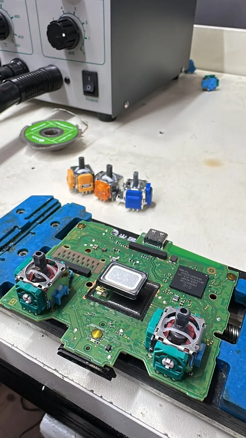 DualSense Kol Drift Onarımı — Anakarttan sökülen analog modüller ve lehim istasyonu